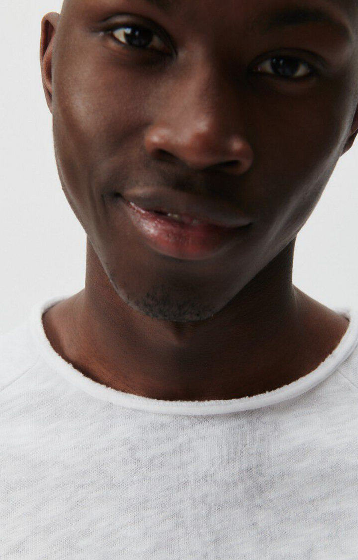 A very close up image of the lower half of the male models face and upper half of the neckline of the Sonoma Long Sleeve in white