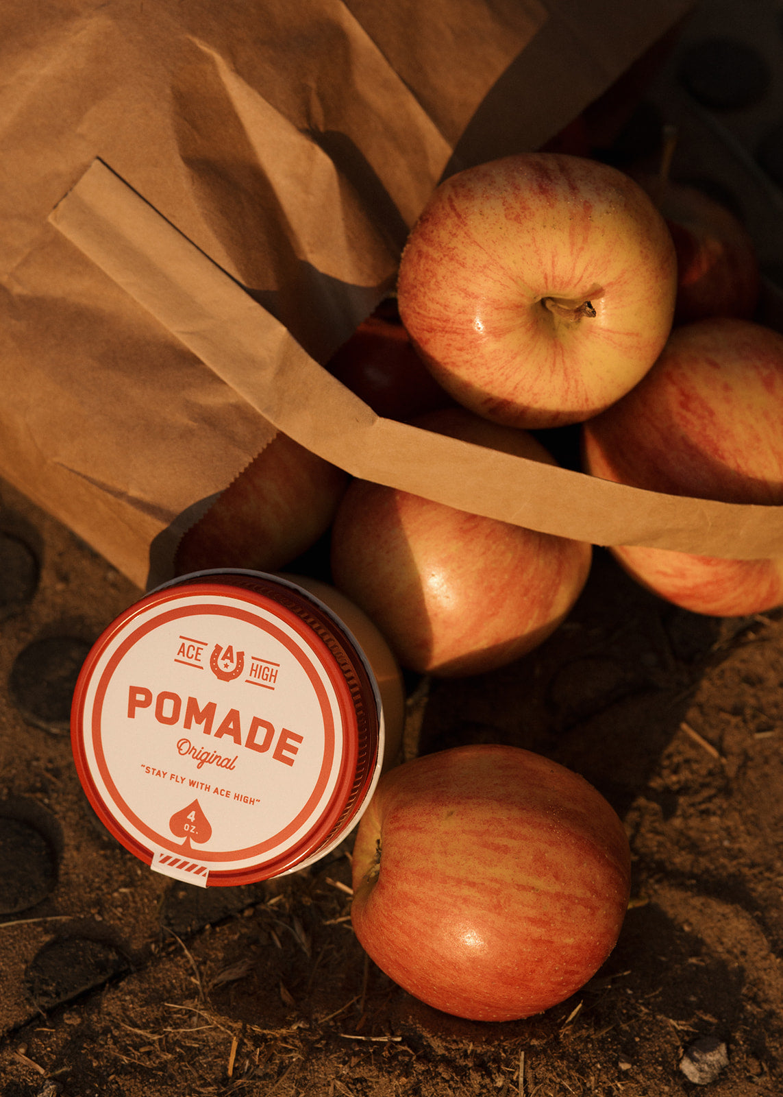 Container of pomade with apples on a rustic background