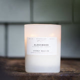 Candle in a frosted cream glass vessel