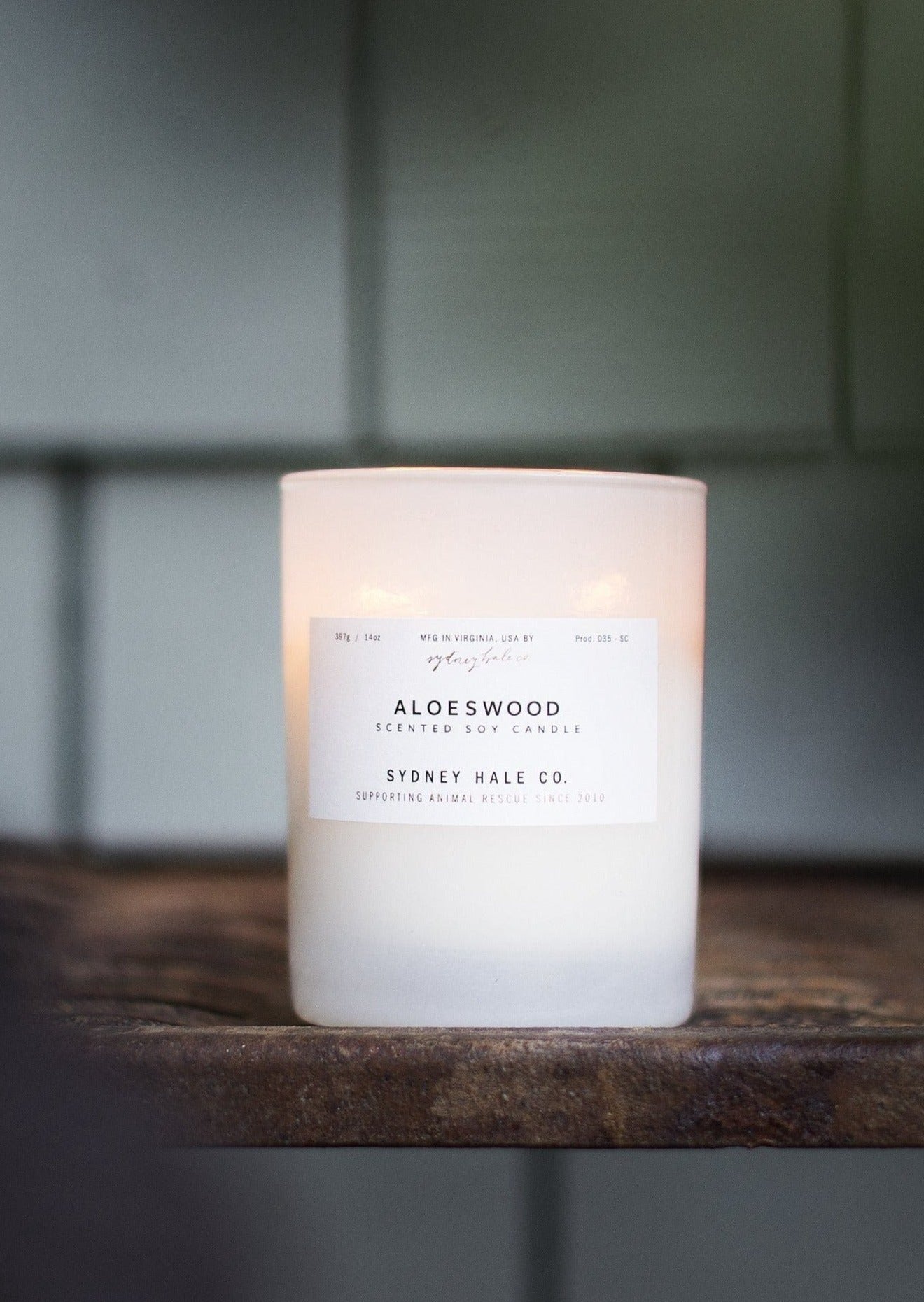 Candle in a frosted cream glass vessel