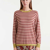 Woman wearing a striped sweater with a plain background