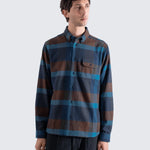 Man wearing a striped shirt with blue and brown colors on a white background