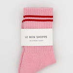 Pink socks with red stripes in Le Bon Shoppe packaging.