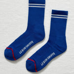 A pair of blue socks with white stripes on a white background.