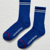 A pair of blue socks with white stripes on a white background.