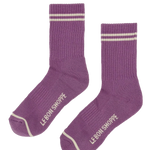 Purple socks with white stripes and 'Le Bon Shoppe' branding on a white background