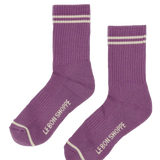 Purple socks with white stripes and 'Le Bon Shoppe' branding on a white background