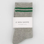 Gray socks with green stripes and a visible brand label on a white background