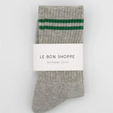 Gray socks with green stripes and a visible brand label on a white background