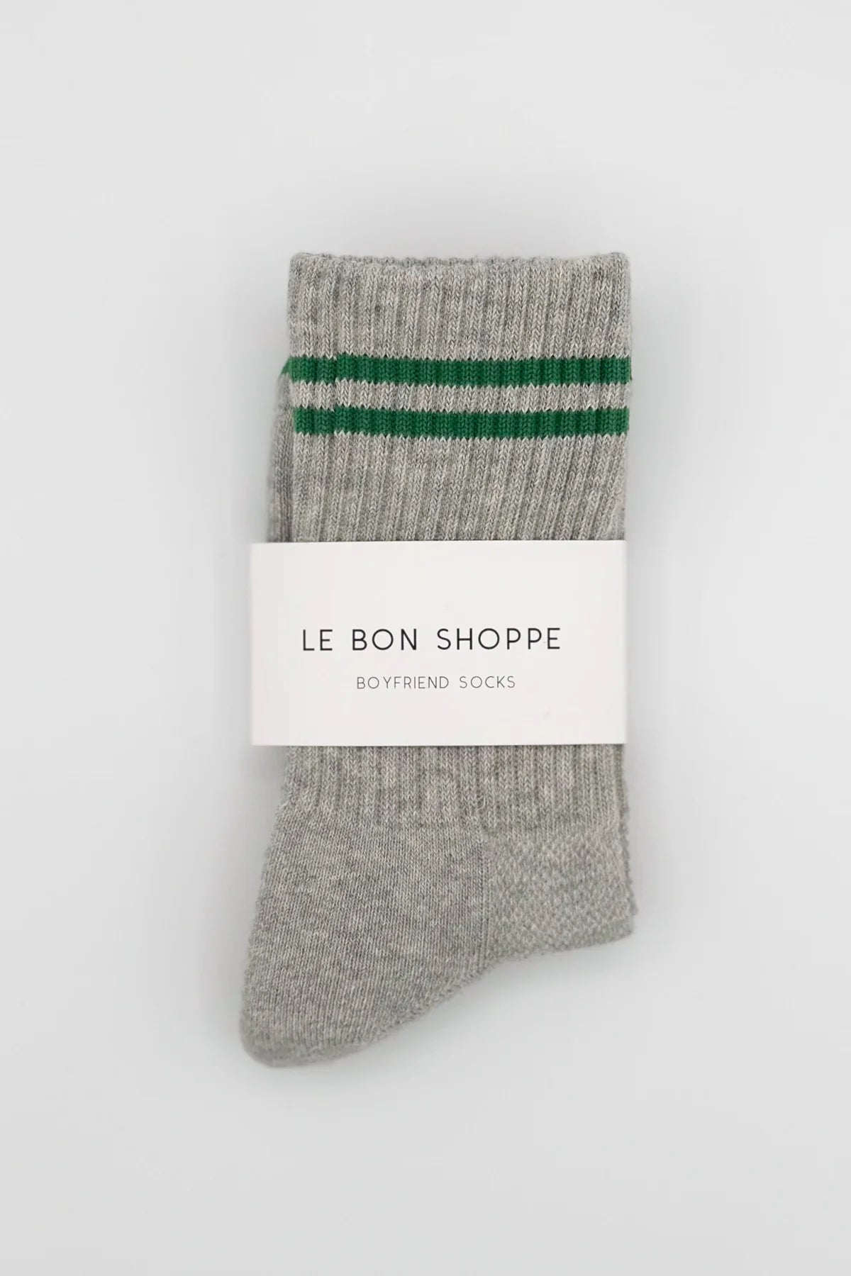 Gray socks with green stripes and a visible brand label on a white background