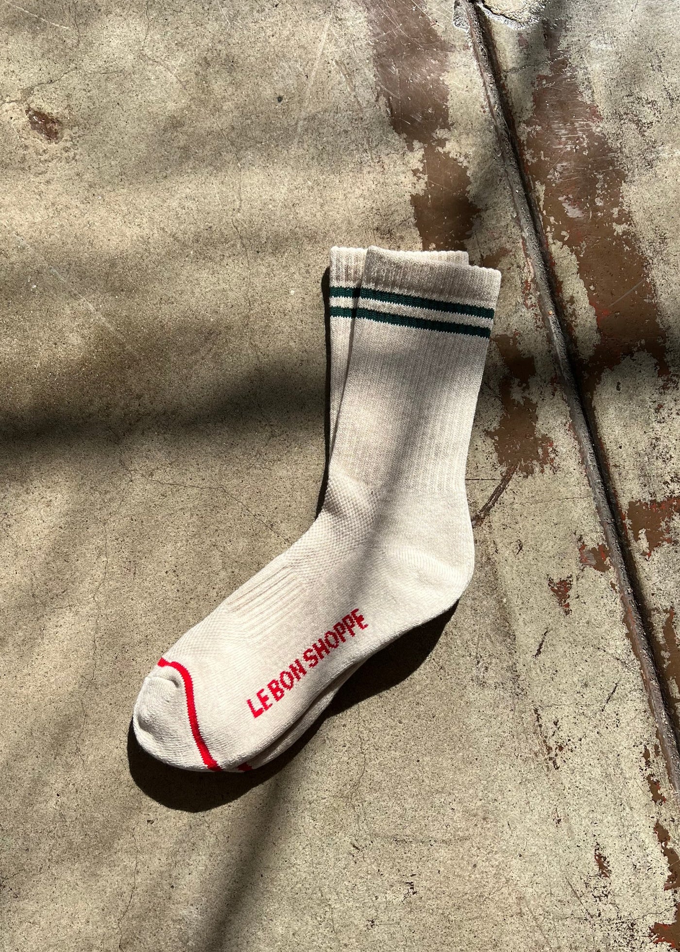 White socks with green stripes and red stripe along the toe and Le Bon Shoppe branding.