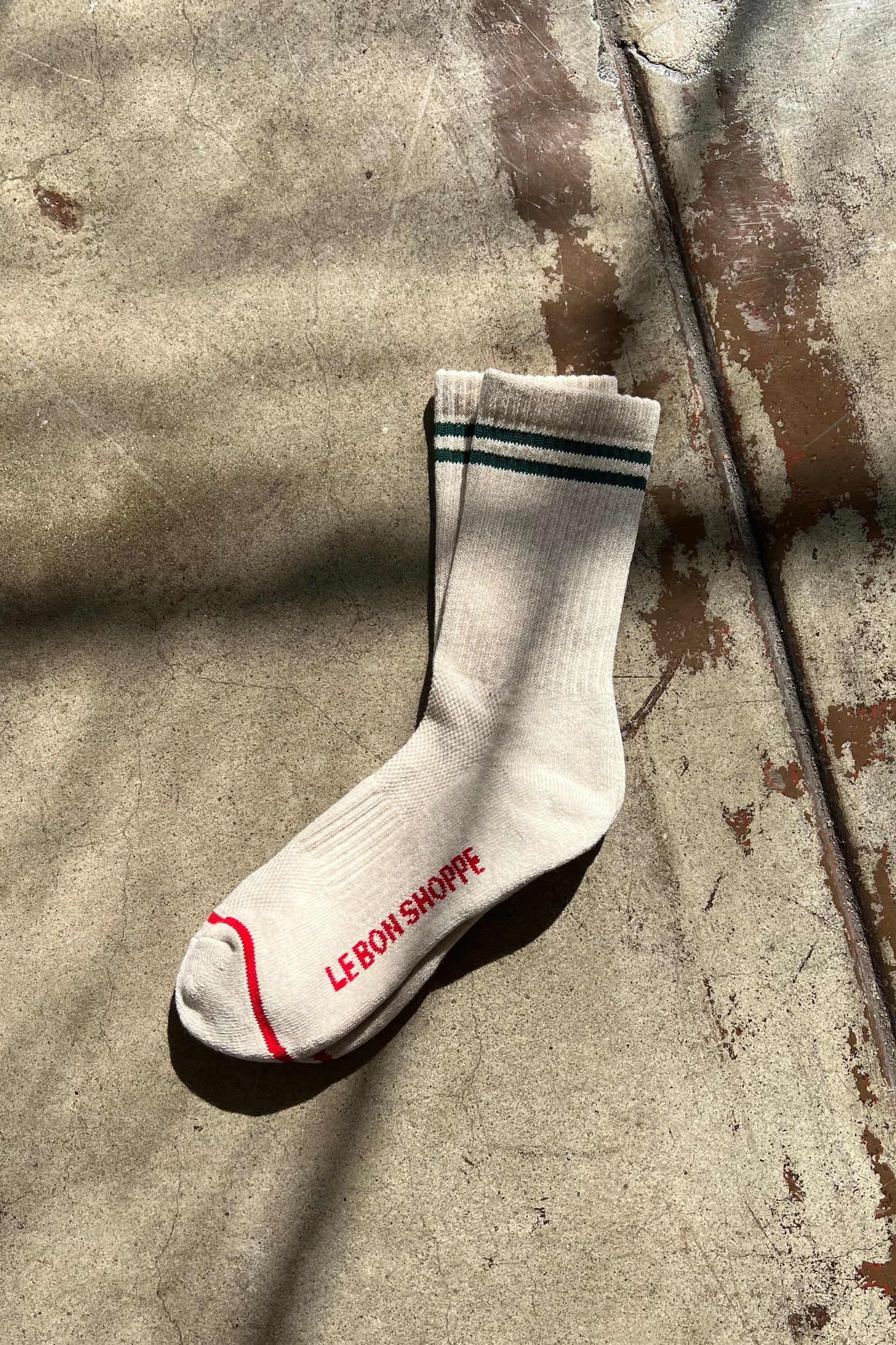 White socks with green stripes and red stripe along the toe and Le Bon Shoppe branding.