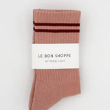 Pink socks with red stripes in white Le Bon Shoppe packaging on white background.