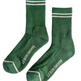 Green socks with white stripes an Le Bon Shoppe branding on white background.