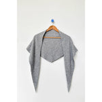 Gray cardigan on a wooden hanger against a white background