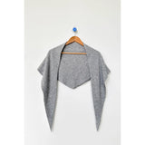 Gray cardigan on a wooden hanger against a white background