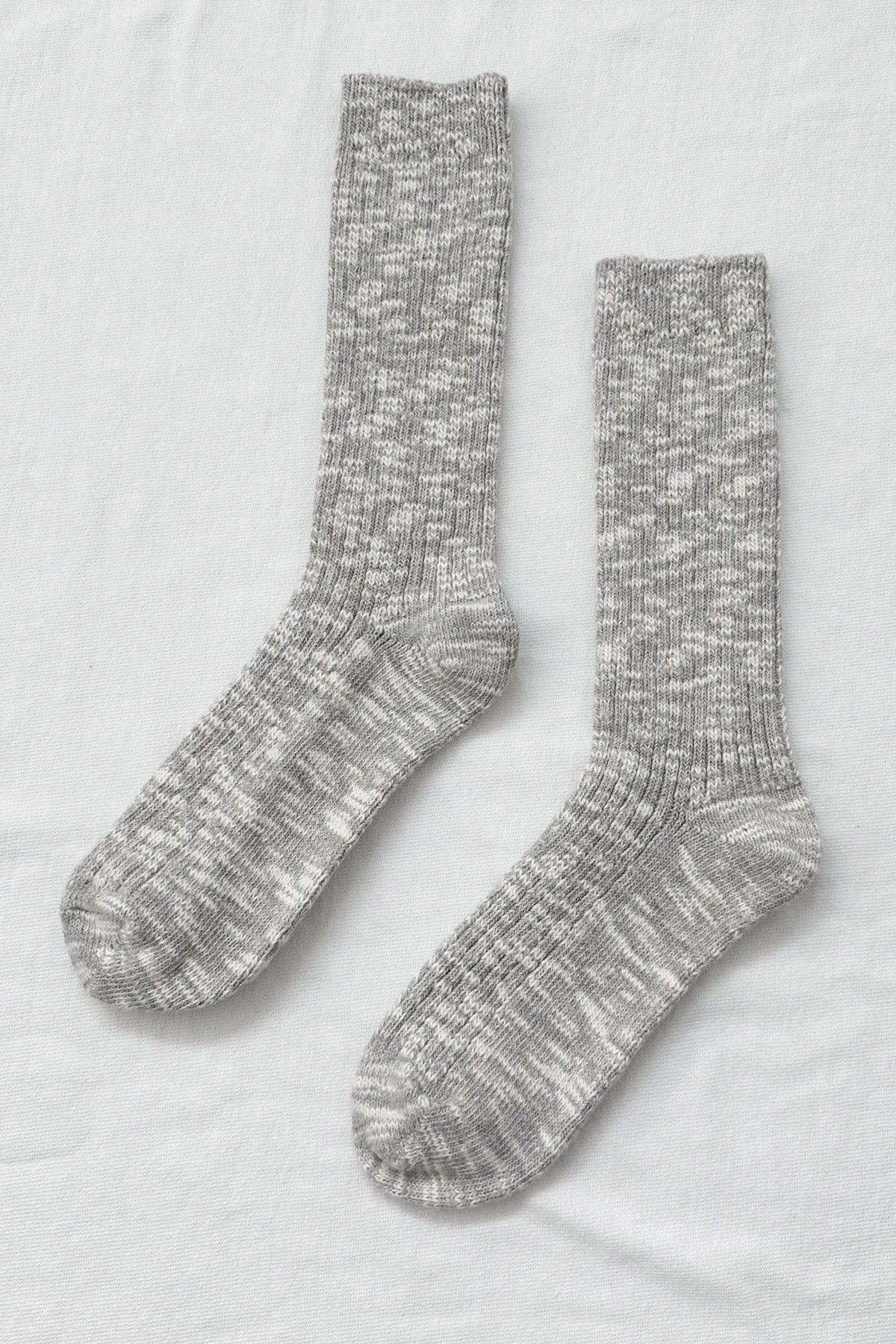 Pair of gray marled socks on a light gray background