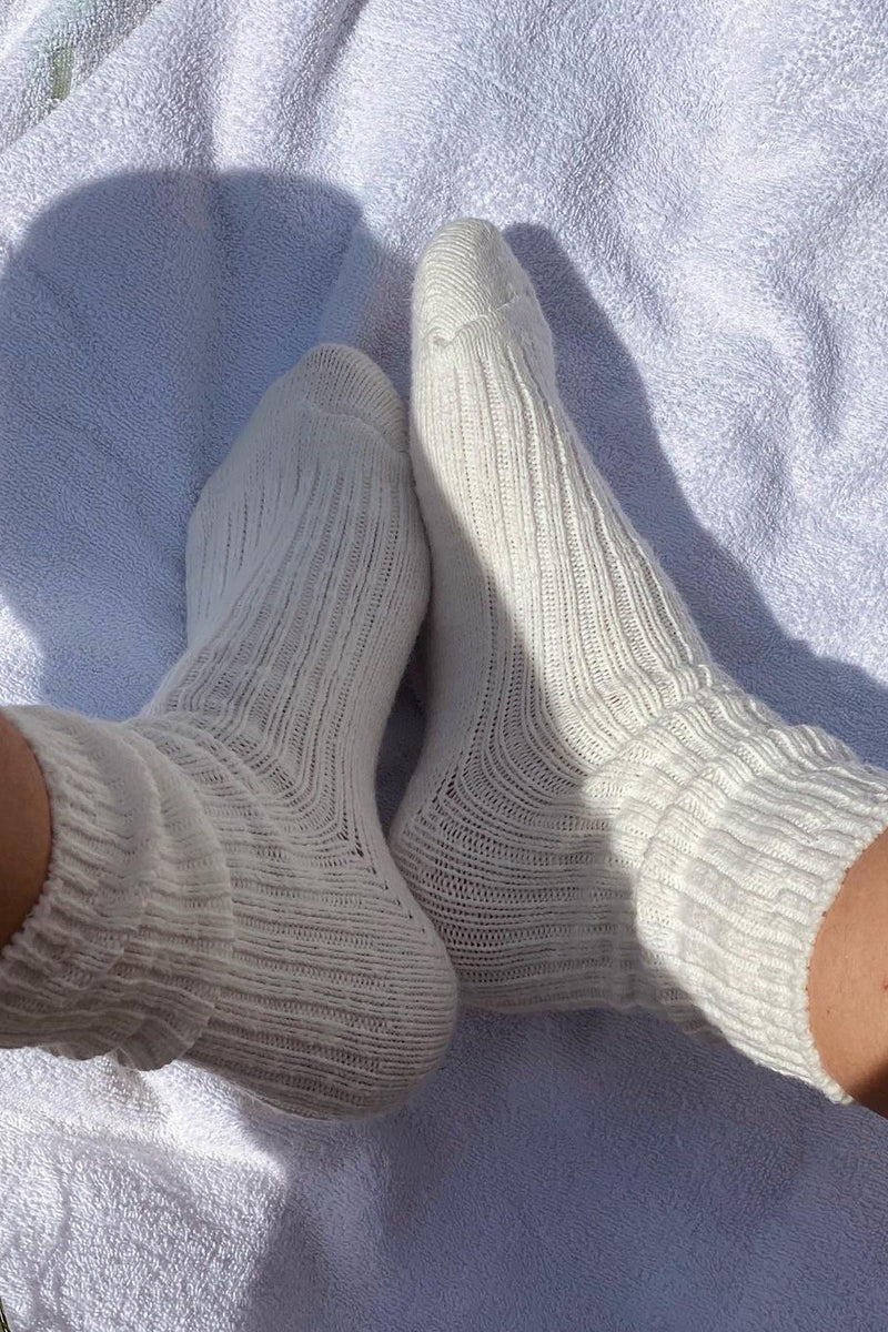Pair of gray socks on a white towel