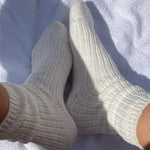 Pair of gray socks on a white towel