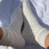 Pair of gray socks on a white towel