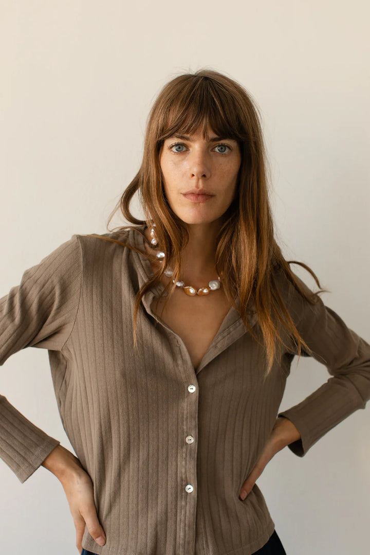 A head shot image of a female model wearing the Pointelle Cardigan 