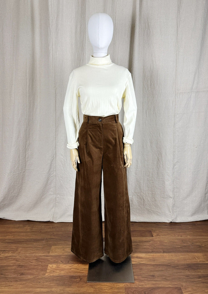 Full image showing the Pointelle Turtleneck styled on a mannequin with a wide leg brown pant