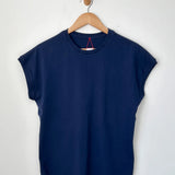 Navy blue t-shirt on a wooden hanger against a white background