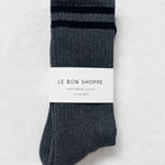 Pair of gray socks with a label on a light gray background
