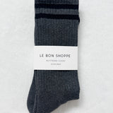 Pair of gray socks with a label on a light gray background