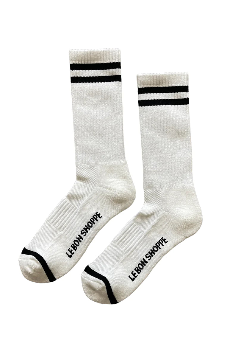 White socks with black stripes and Le Bon Shoppe branding on white background