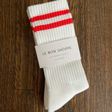 White socks in Le Bon Shoppe packaging on wood background