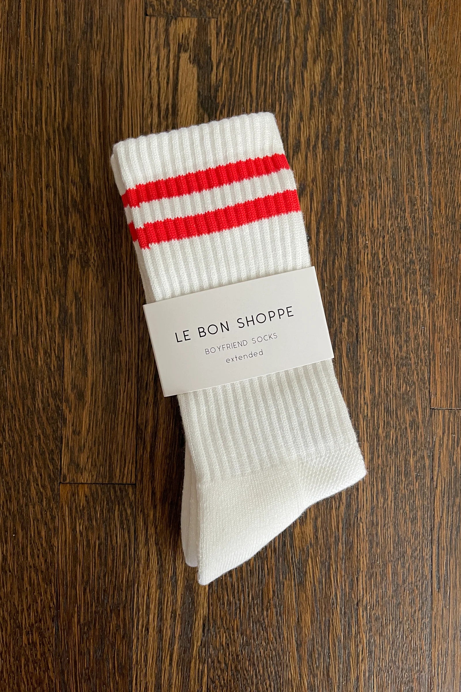 White socks in Le Bon Shoppe packaging on wood background