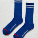 Cobalt socks with white stripes and Le Bon Shoppe branding on white background.