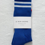 Cobalt socks with white stripes in Le Bon Shoppe packaging on white background.