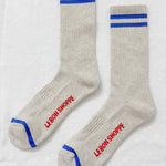 Pair of gray socks with blue stripes and red text on a white background