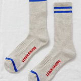 Pair of gray socks with blue stripes and red text on a white background