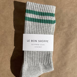 Gray sock with green stripes on a brown background, featuring 'Le Bon Shoppe' label.