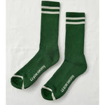 Green socks with white stripes and Le Bon Shoppe branding on white background