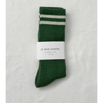 Green socks with white stripes in Le Bon Shoppe packaging on white background
