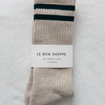 Pair of beige socks with green stripes on a light gray background, featuring a 'Le Bon Shoppe' label.
