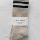 Pair of beige socks with green stripes on a light gray background, featuring a 'Le Bon Shoppe' label.