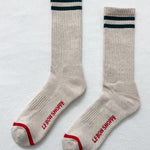 Pair of beige socks with blue and red accents on a light gray background