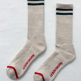 Pair of beige socks with blue and red accents on a light gray background