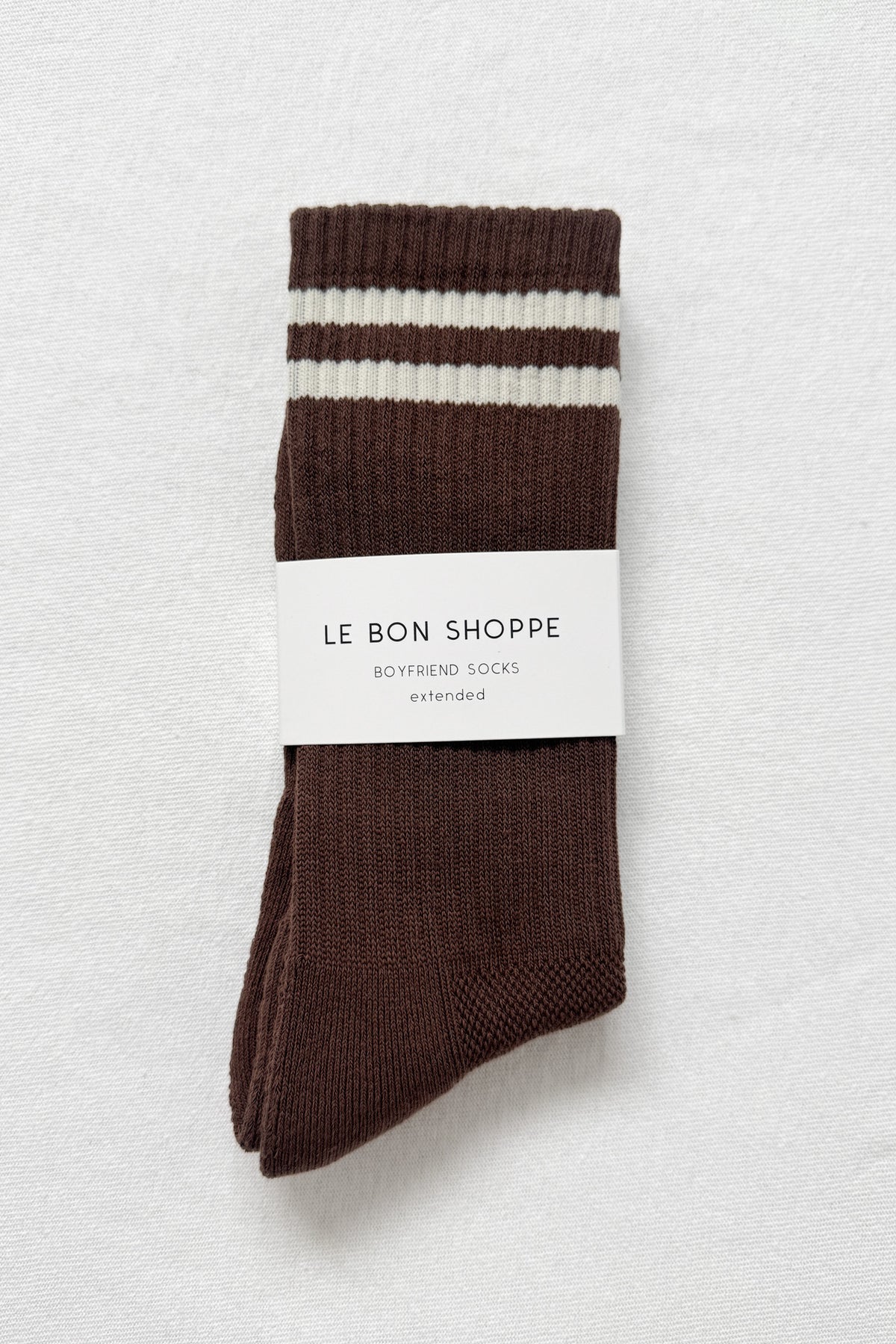 Brown socks with white stripes on a light gray background, featuring 'Le Bon Shoppe' branding.