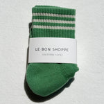 Green striped sock with 'Le Bon Shoppe' label on a light gray background