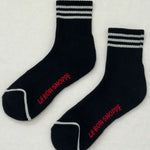 Black socks with white stripes and red Le Bon Shoppe branding on white background