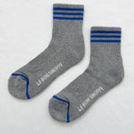 Grey socks with blue stripes on a white background