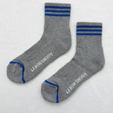 Grey socks with blue stripes on a white background