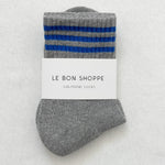 Grey socks with blue stripes in white Le Bon Shoppe packaging on white background