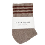 Pair of brown striped socks with a white label on a white background